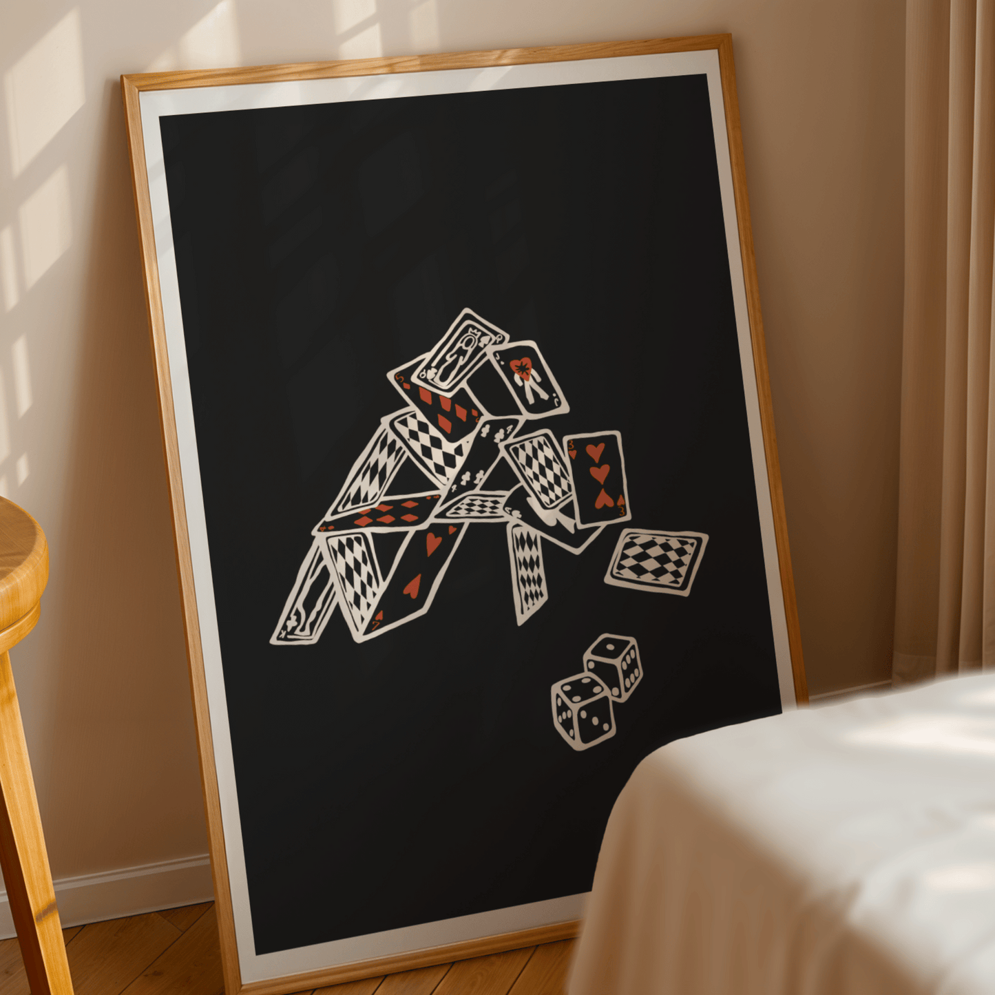  A modern wall print featuring a minimalist playing card design, displayed above a bed in a cozy bedroom. The artwork has a sleek, monochrome aesthetic with bold red and black card symbols, adding a stylish and contemporary touch to the room.