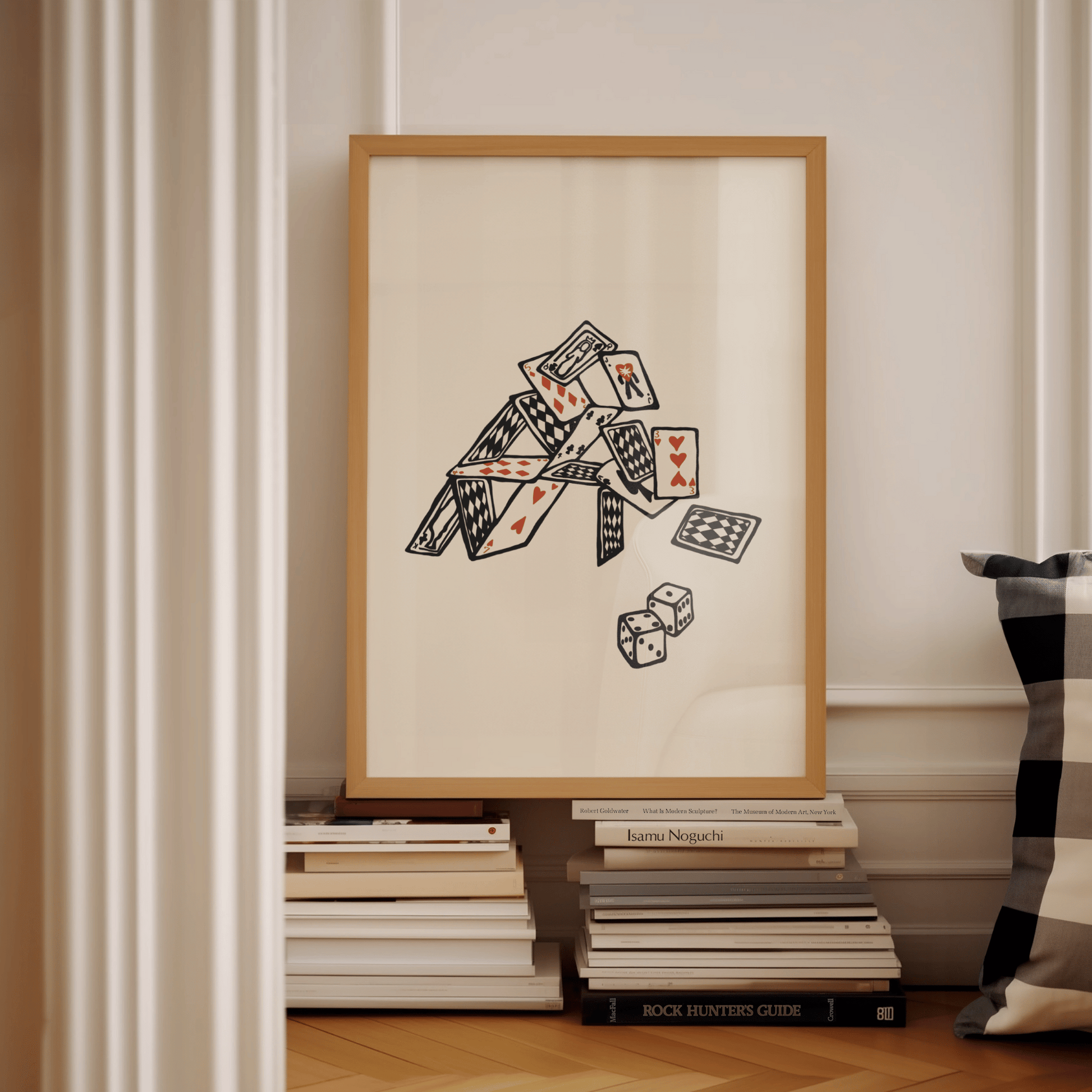  A modern wall print featuring a minimalist playing card design, on books within a modern office. The artwork has a sleek, monochrome aesthetic with bold red and black card symbols, adding a stylish and contemporary touch to the room.