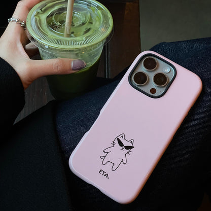 Pink phone case with a cat illustration and 'ETA' text, next to a hand holding a green drink.